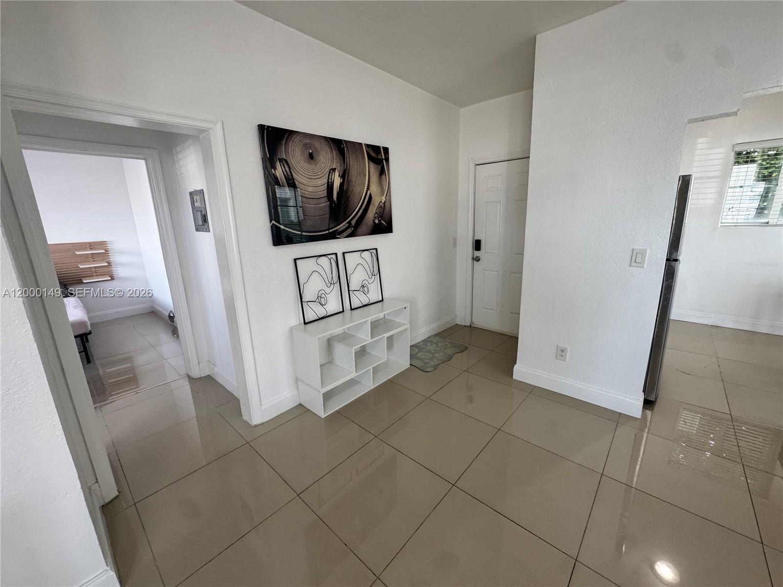 8415 Harding Avenue, Unit 9 Miami Beach, FL 33141 - Photo 2 of 14 a view of a livingroom with wooden floor and a flat screen tv