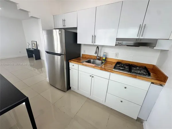a kitchen with stainless steel appliances granite countertop a refrigerator sink and cabinets