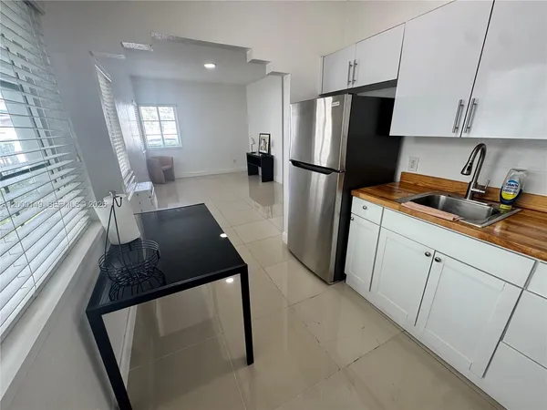 a kitchen with a refrigerator and a stove