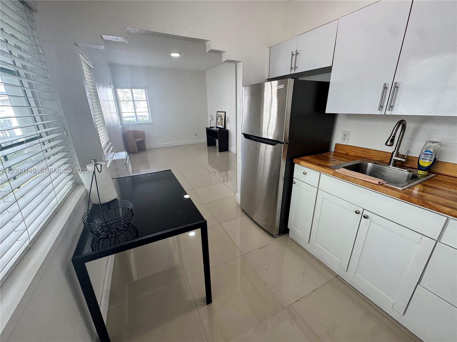 8415 Harding Avenue, Unit 9 Miami Beach, FL 33141 - Photo 5 of 14 a kitchen with a refrigerator and a stove