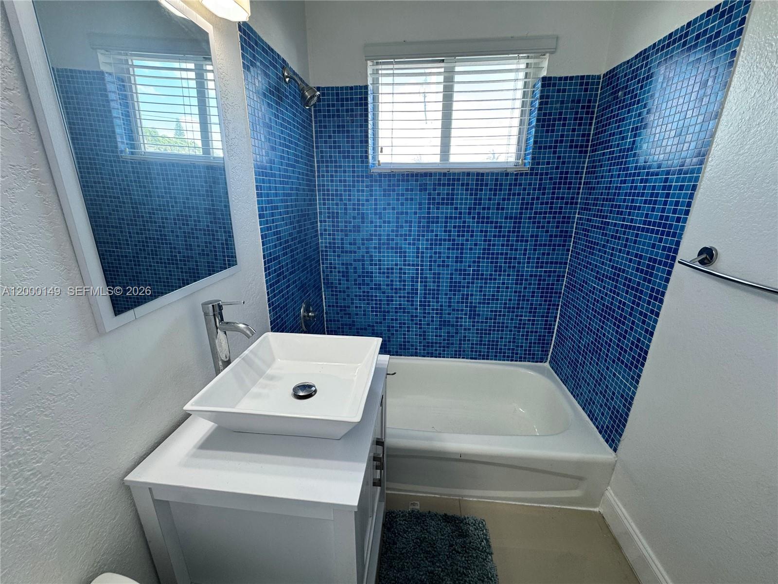 8415 Harding Avenue, Unit 9 Miami Beach, FL 33141 - Photo 6 of 14 a bathroom with a sink and a toilet