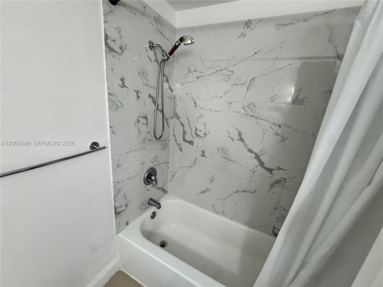 8415 Harding Avenue, Unit 9 Miami Beach, FL 33141 - Photo 9 of 14 a bathroom with a bathtub