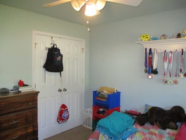 116 Nealys Way Haddock, GA 31033 - Photo 12 of 20 a bedroom with a bed and a chandelier
