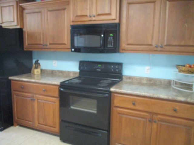 116 Nealys Way Haddock, GA 31033 - Photo 7 of 20 a kitchen with granite countertop white cabinets and a stove