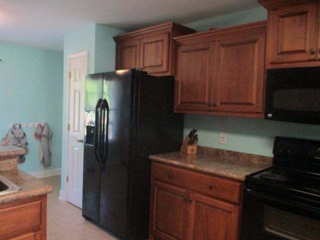 116 Nealys Way Haddock, GA 31033 - Photo 9 of 20 a kitchen with stainless steel appliances granite countertop a refrigerator and a stove top oven