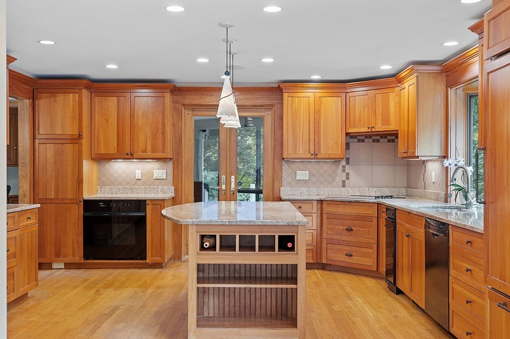 2 Sunset Ridge Lexington, MA 02421 - Photo 33 of 39 a kitchen with kitchen island granite countertop a stove a sink and a refrigerator