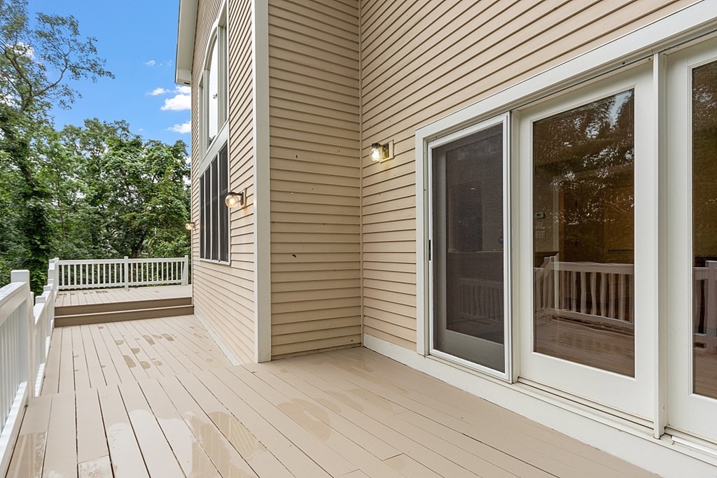 2 Sunset Ridge Lexington, MA 02421 - Photo 5 of 39 a view of a balcony with wooden floor and fence