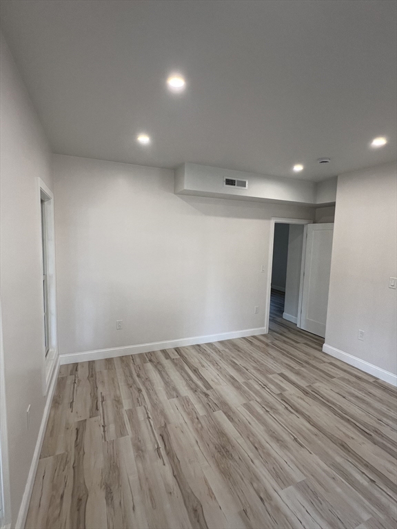 31 Old Morton Street, Unit 1 Boston, MA 02126 - Photo 14 of 17 a view of empty room with wooden floor