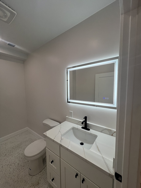 31 Old Morton Street, Unit 1 Boston, MA 02126 - Photo 5 of 17 a bathroom with a sink toilet and mirror