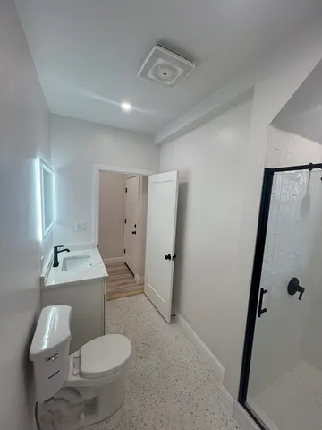 a bathroom with a sink toilet and shower