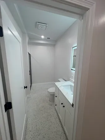 a bathroom with a granite countertop sink toilet and shower