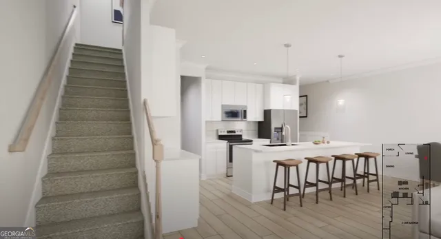 a kitchen with stainless steel appliances a stove top oven a sink refrigerator and cabinets