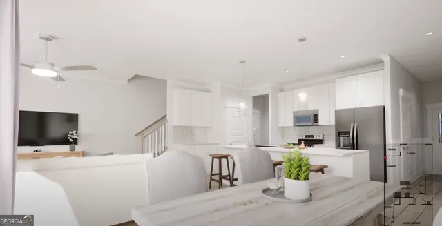 a kitchen with stainless steel appliances a dining table a microwave a refrigerator and a dining table with wooden floor