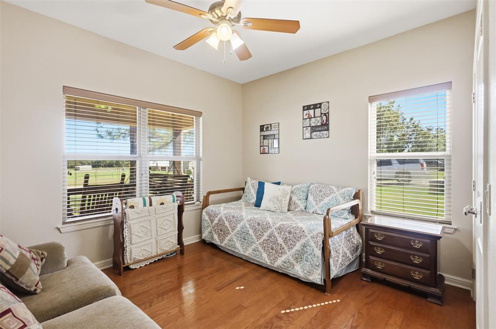 207 Dennis Road Lipan, TX 76462 - Photo 23 of 40 Vaulted ceiling with a ceiling fan, wood-finish flooring, and multiple windows with blinds