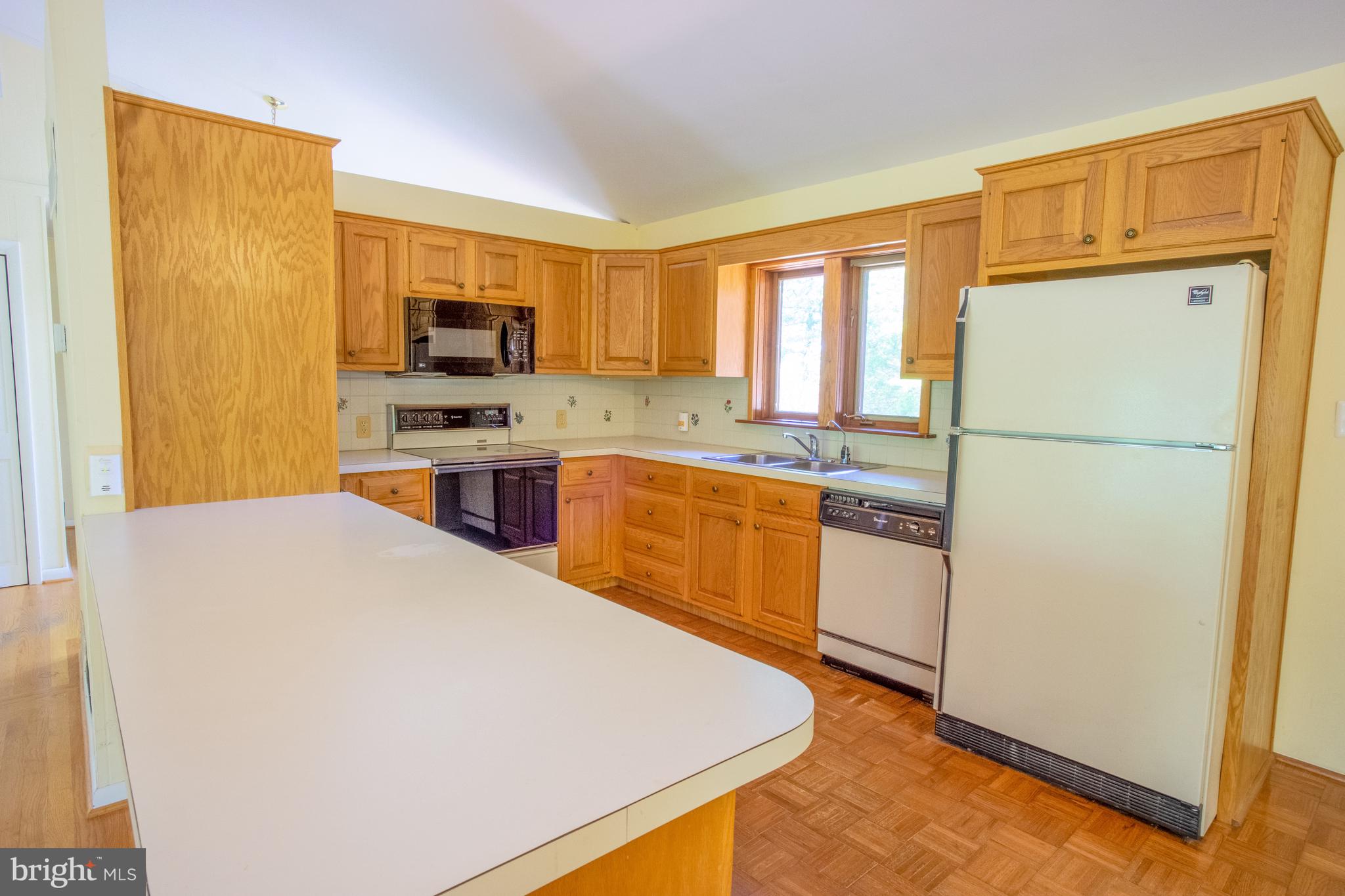 132 Union Church Road Elkton, MD 21921 - Photo 7 of 41 a kitchen with a refrigerator a stove top oven and a window