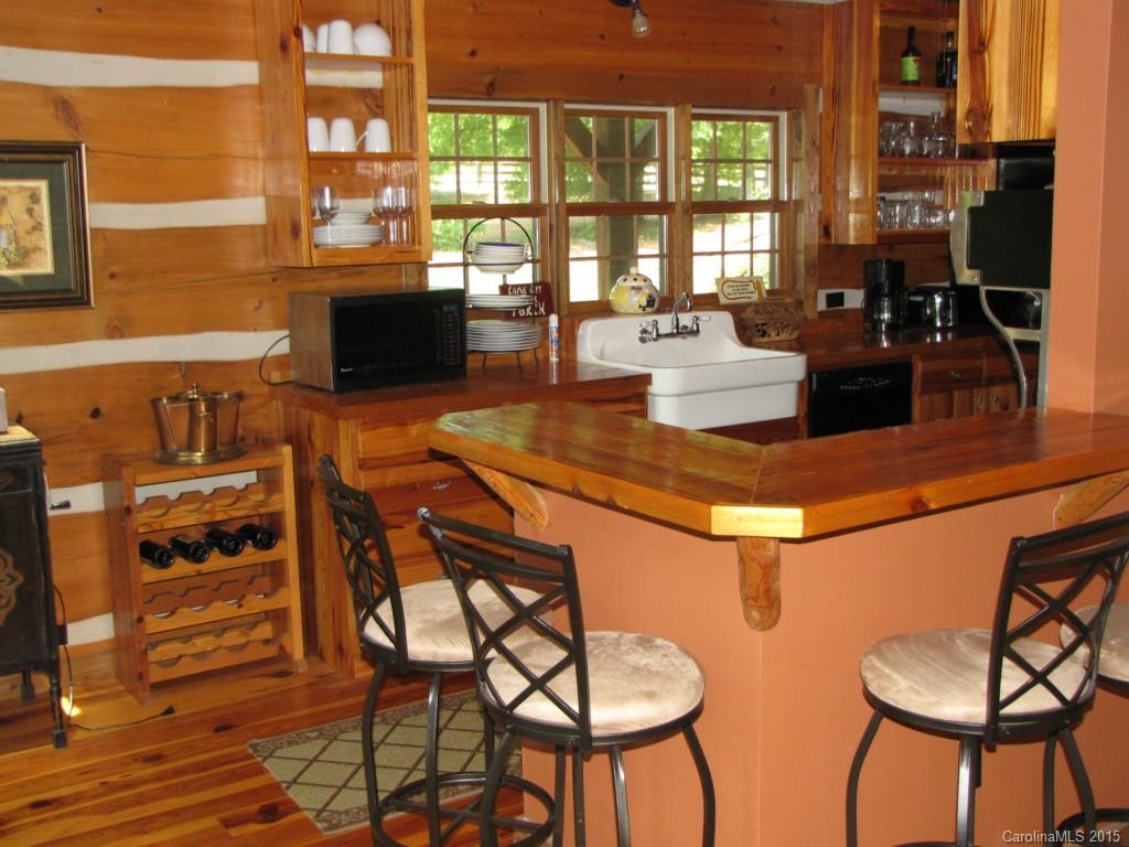 395 Tallow Road, Unit 11 Ridgeway, SC 29130 - Photo 7 of 24 a kitchen with stainless steel appliances granite countertop a stove a sink and a dining table