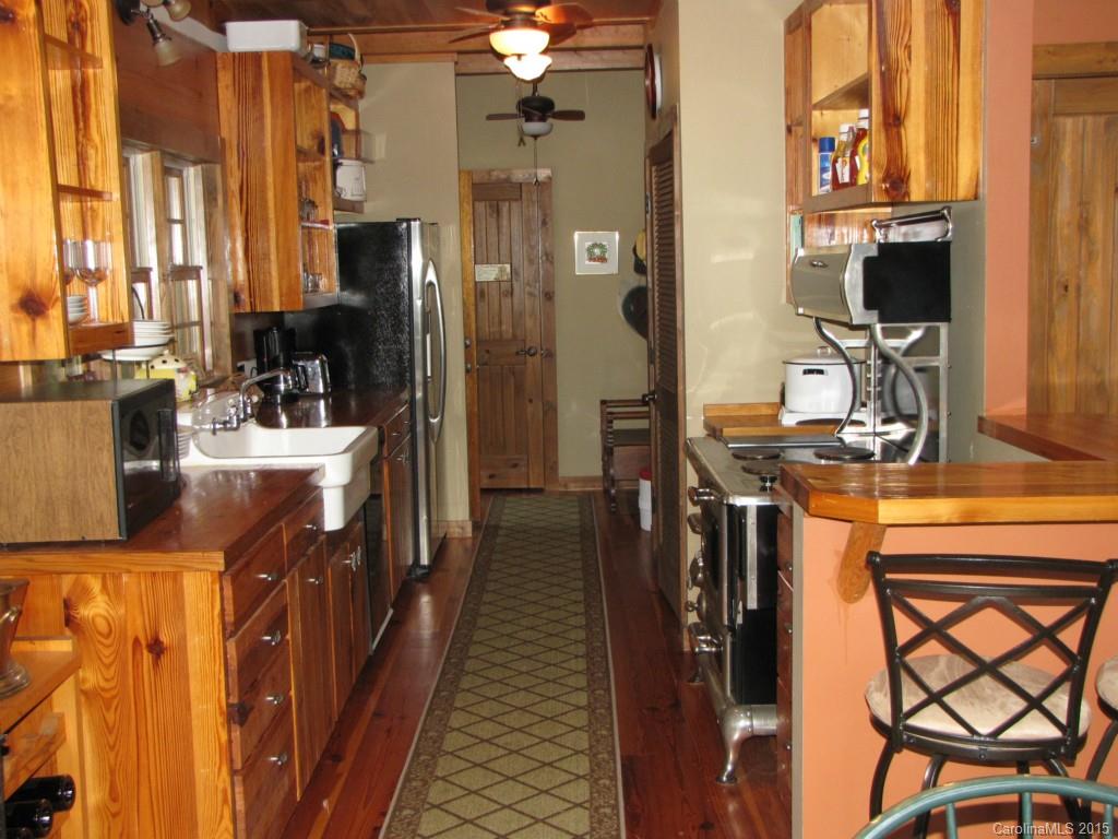 395 Tallow Road, Unit 11 Ridgeway, SC 29130 - Photo 10 of 24 a kitchen with stainless steel appliances kitchen island granite countertop a refrigerator and a stove top oven