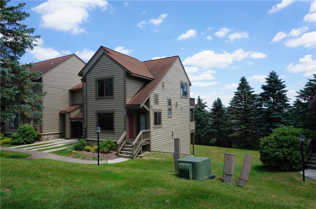 a front view of house with a garden