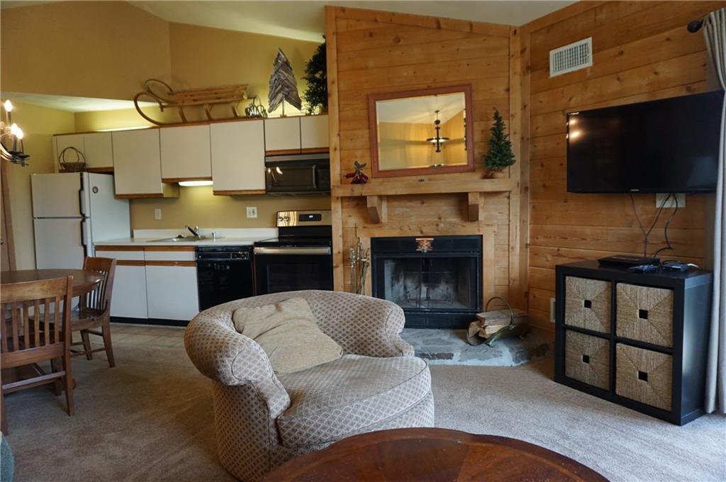 Y12 Sunridge Road Champion, PA 15622 - Photo 6 of 15 a living room with furniture a flat screen tv and a fireplace