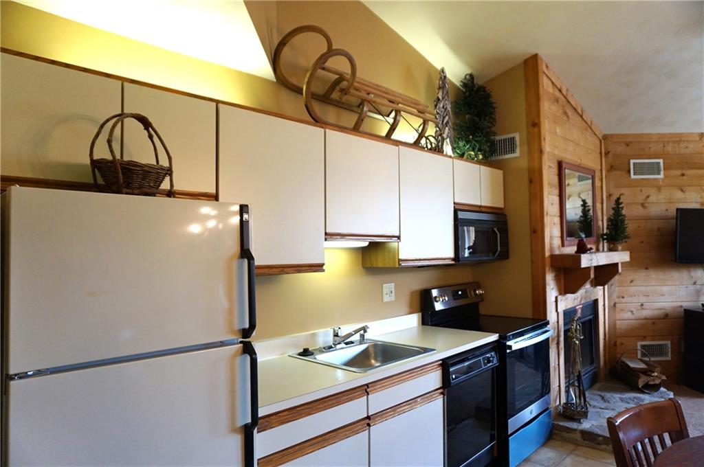 Y12 Sunridge Road Champion, PA 15622 - Photo 8 of 15 a kitchen with stainless steel appliances granite countertop a sink a stove and a refrigerator