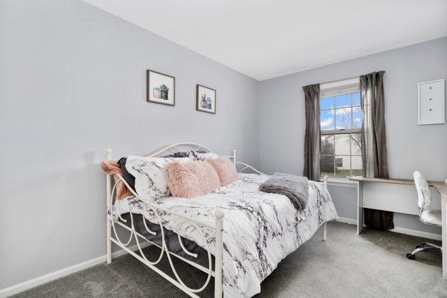 43 North Oltendorf Road Streamwood, IL 60107 - Photo 14 of 22 a bed sitting in a bedroom next to a window with lamp