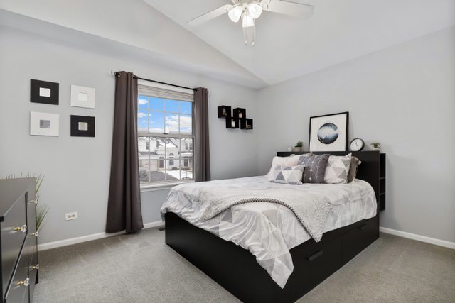 43 North Oltendorf Road Streamwood, IL 60107 - Photo 16 of 22 a bedroom with a large bed and a chandelier