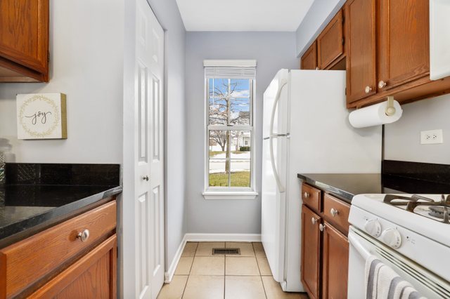 43 North Oltendorf Road Streamwood, IL 60107 - Photo 6 of 22 a view of a kitchen with fridge and wooden floor