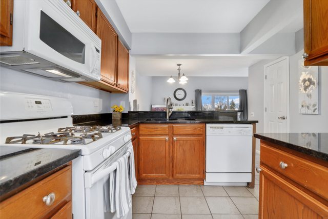 43 North Oltendorf Road Streamwood, IL 60107 - Photo 7 of 22 a kitchen with stainless steel appliances granite countertop a stove a sink and a microwave