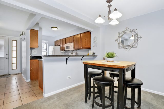 43 North Oltendorf Road Streamwood, IL 60107 - Photo 8 of 22 a dining room filled chandelier and wooden floor