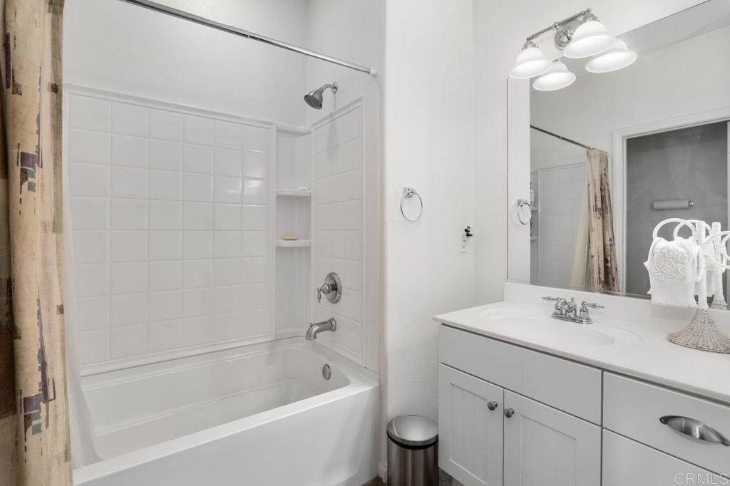 810 Harbor Cliff Way, Unit 225 Oceanside, CA 92054 - Photo 11 of 43 a bathroom with a tub sink and mirror