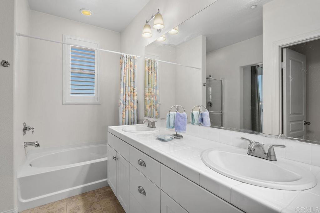 810 Harbor Cliff Way, Unit 225 Oceanside, CA 92054 - Photo 15 of 43 a bathroom with a sink double vanity granite tub and shower