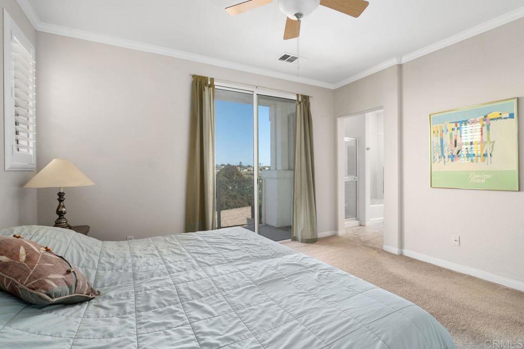 810 Harbor Cliff Way, Unit 225 Oceanside, CA 92054 - Photo 22 of 43 a bedroom with a large bed and a chandelier