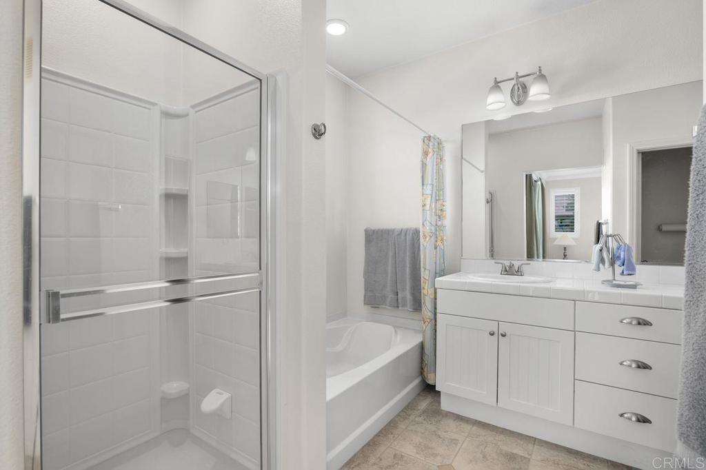 810 Harbor Cliff Way, Unit 225 Oceanside, CA 92054 - Photo 23 of 43 a bathroom with a tub a sink a mirror and a shower