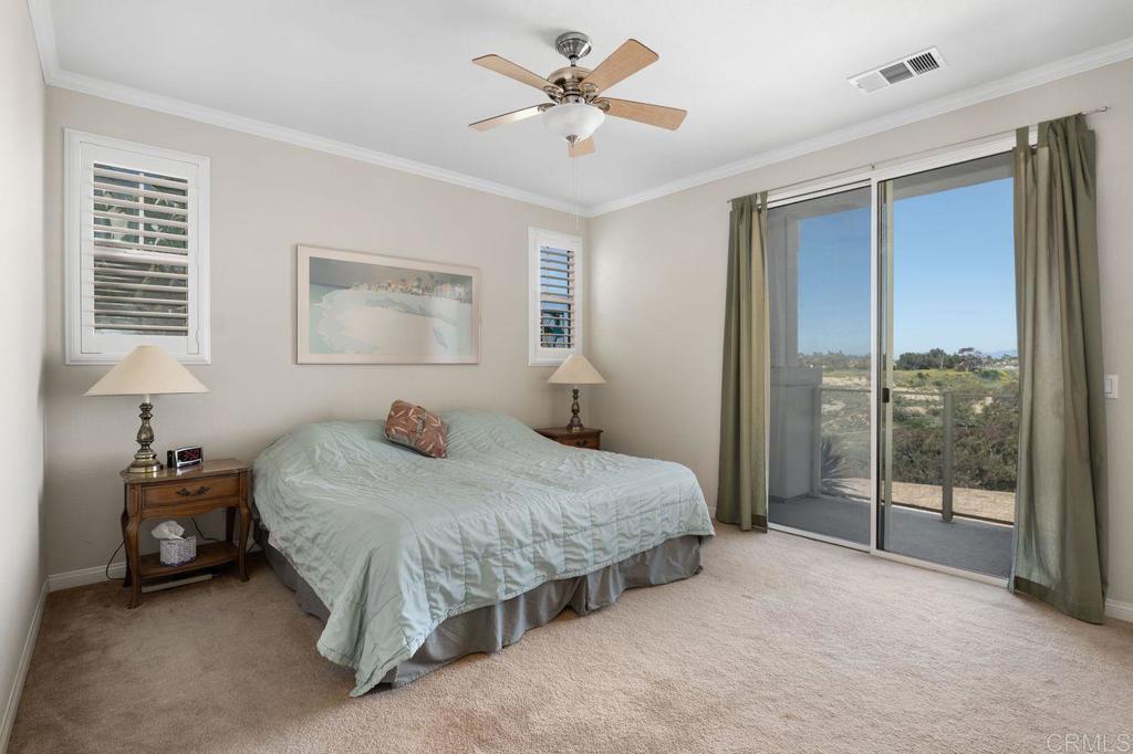 810 Harbor Cliff Way, Unit 225 Oceanside, CA 92054 - Photo 24 of 43 a bedroom with a bed and a large window