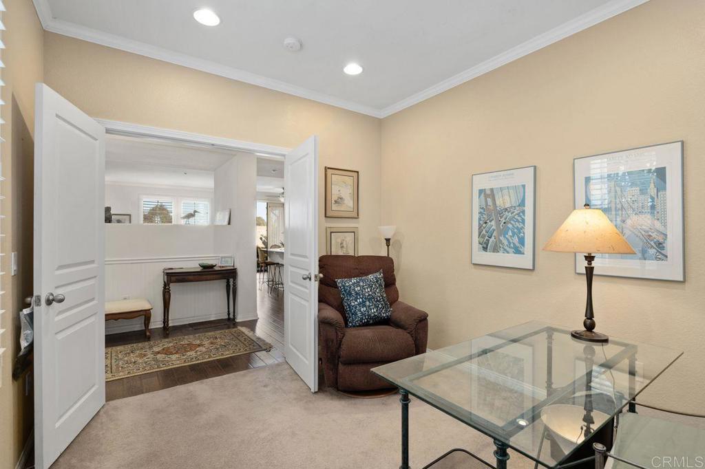 810 Harbor Cliff Way, Unit 225 Oceanside, CA 92054 - Photo 28 of 43 a living room with furniture a lamp and a window
