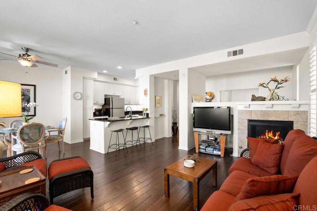 810 Harbor Cliff Way, Unit 225 Oceanside, CA 92054 - Photo 32 of 43 a living room with furniture a fireplace and a flat screen tv