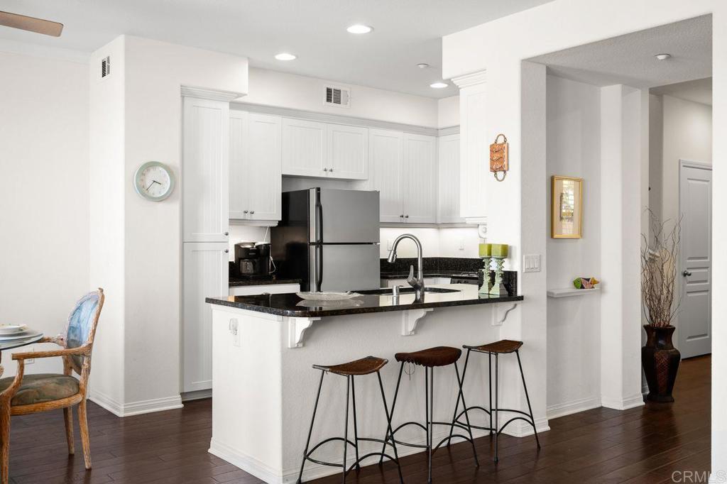 810 Harbor Cliff Way, Unit 225 Oceanside, CA 92054 - Photo 33 of 43 a kitchen with stainless steel appliances a sink and a refrigerator