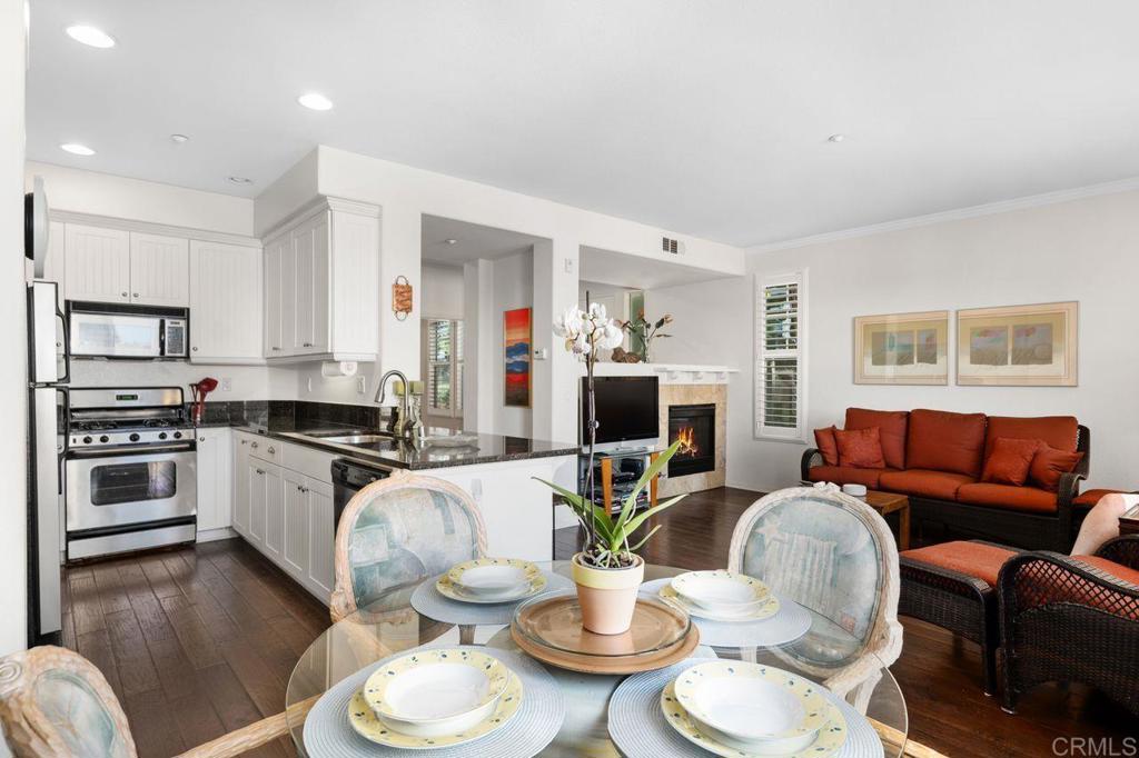 810 Harbor Cliff Way, Unit 225 Oceanside, CA 92054 - Photo 36 of 43 a living room with furniture a fireplace and a window