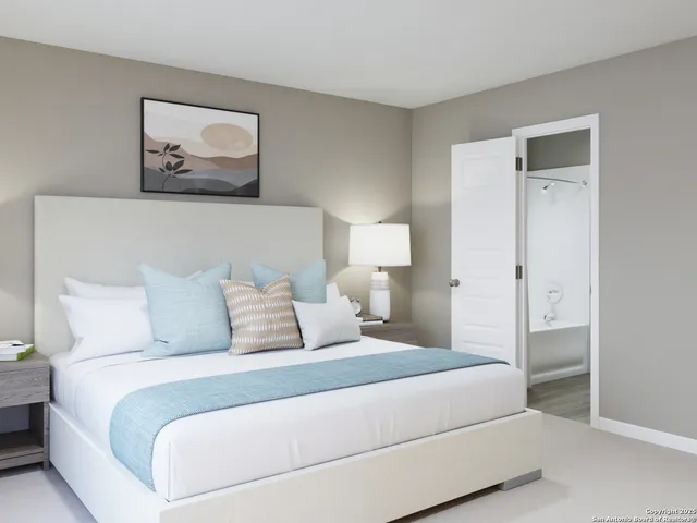 a bedroom with a bed and painting on the wall