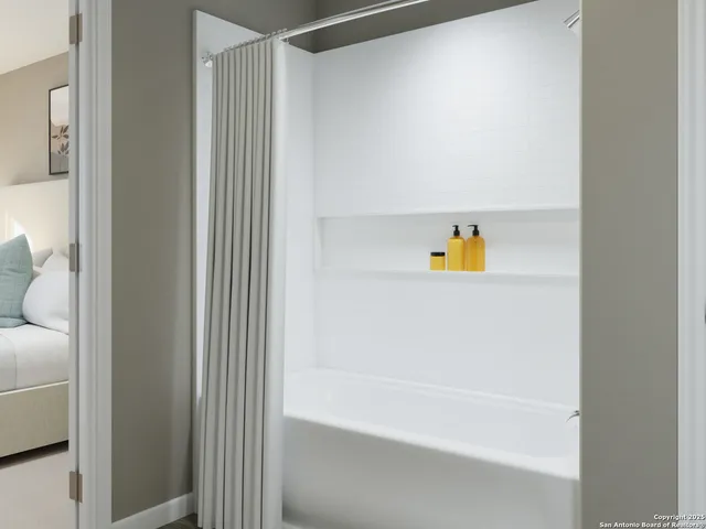 a bathroom with a bathtub and a shower