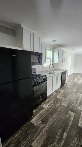 a kitchen with stainless steel appliances a refrigerator sink and cabinets