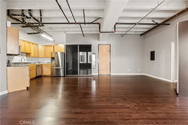 a view of a kitchen with a stove and wooden floor