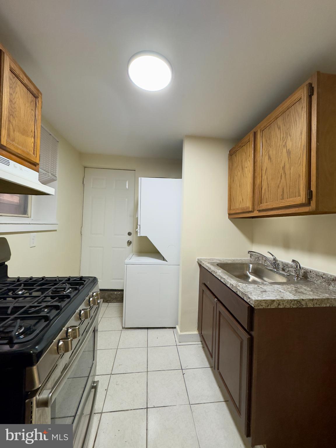 2102 Maryland Avenue Baltimore, MD 21218 - Photo 13 of 14 a kitchen with a sink stove and cabinets