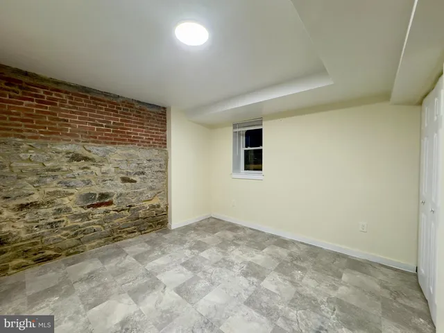 a view of an empty room and a bathroom
