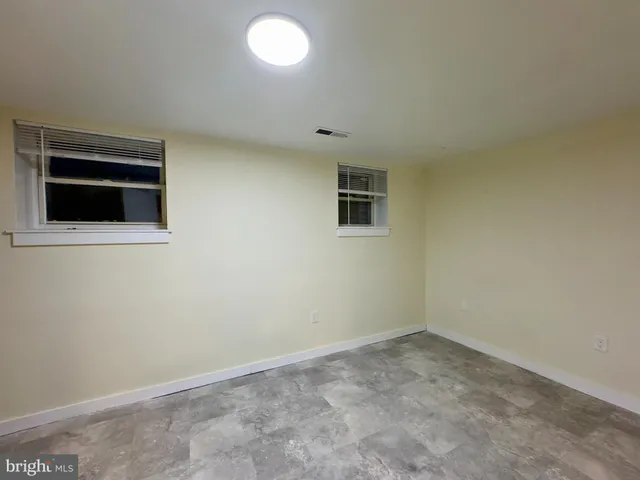 an empty room with closet and bathroom
