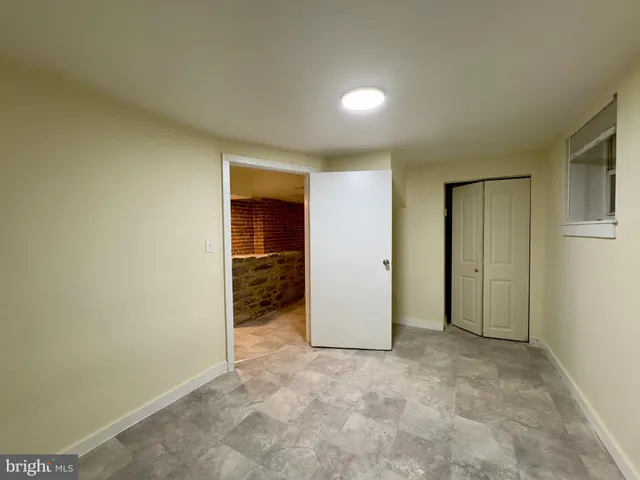 a kitchen with granite countertop a refrigerator and a stove top oven