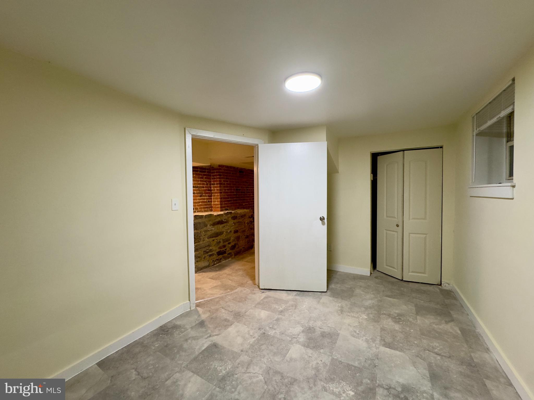 2102 Maryland Avenue Baltimore, MD 21218 - Photo 9 of 14 an empty room with closet and bathroom