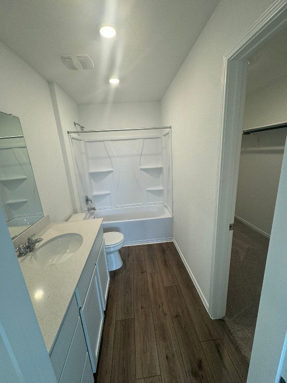 134 Avre Loop Kyle, TX 78640 - Photo 5 of 9 Full master bath with vanity, dark wood finished floors, shower / tub combination, a walk in closet, and recessed lighting