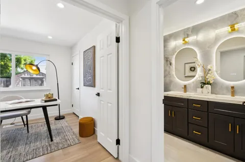 a bathroom with a sink mirror vanity and toilet