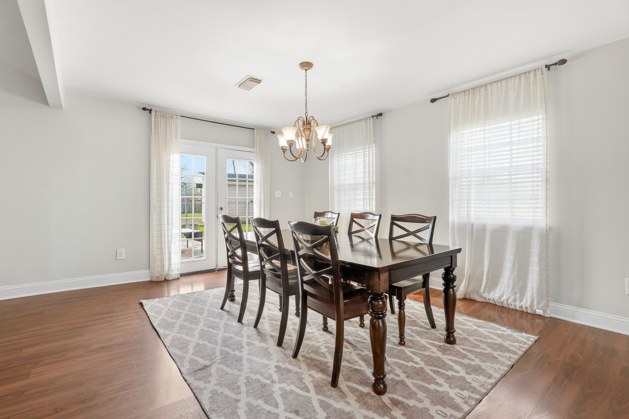 2104 Rose Road Pearland, TX 77581 - Photo 17 of 43 a view of a a dining room with furniture window and wooden floor